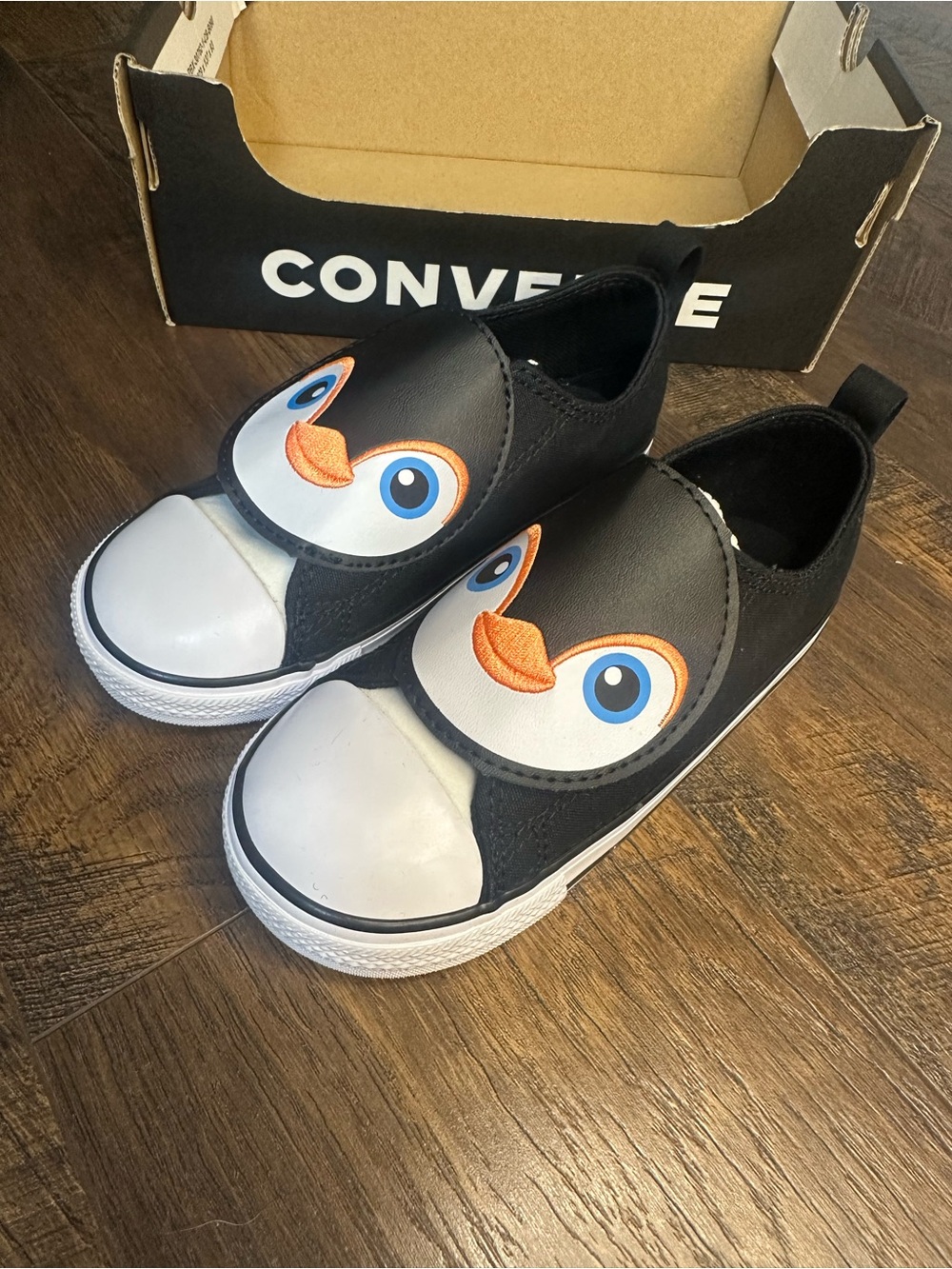 Converse Kids Black Penguin Slip-On Sneakers with Blue Eyes and Orange Beak